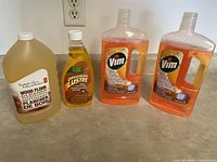 Three bottles of wood floor cleaning liquids: PC Wood Floor Cleaner 1L, Original Lustre Wood Cleaner and Polish 473ml, and two bottles of Vim Wood Floor Cleaner 1L each.