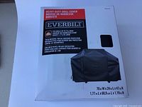 Photo of the Everbilt grill cover packaging showing product information and dimensions.