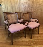 Front view of five chairs showing two armchairs and three side chairs