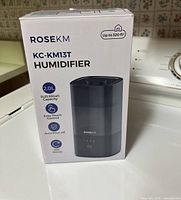 Photo of the Rosekm KC-KM13T humidifier box showing product image, model number, and key features.
