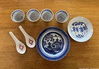 Overview photo of all items in the lot on wooden surface.