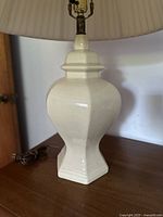 Cream ceramic vintage-style table lamp showing base and socket from side angle