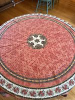 Top-down view of the round tablecloth showing central medallion and overall pattern.