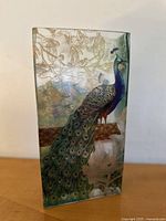 Front view of the glass vase showing the peacock and gold floral detailing.