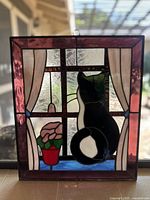 Front view of stained glass panel showing full cat and flower composition