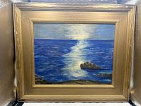 Full front view of framed seascape painting showing overall appearance and frame condition