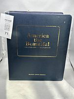 Front cover of the custom blue binder with gold embossed lettering and collector's name