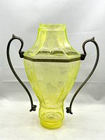 Front view of the yellow uranium glass samovar body with metal handles on both sides.