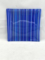 Square fused glass tray with blue and indigo stripes, shot against a white background to show pattern and size.