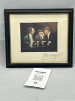 Frontal photo of framed print showing the full artwork and frame with seller's identifier card in front