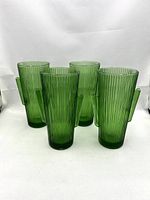Four green glass ribbed tumblers with Saguaro cactus-shaped handles, arranged in a cluster on white background.