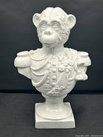 Front view of white porcelain chimpanzee bust showing detailed military uniform.