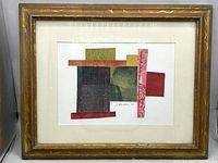 Framed mixed media collage art showing vibrant geometric shapes in red, green, and gold with signature J. Johnston 98 visible on paper. The frame is wooden with a natural gold-ish finish and visible age wear.