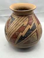 Full side view of the olla showing geometric red, black, and tan painted designs.