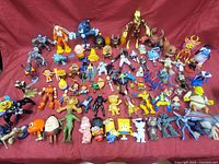 Wide view of the large assortment of various superhero, cartoon, and animal figurines