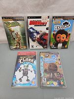 Photo of five PSP game cases titled Daxter, Burnout Dominator, EyePet, Secret Agent Clank, and LittleBigPlanet.