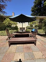 Full front view of dining set with benches, chairs, and umbrella