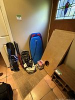 Full view of lot contents including cornhole boards, bean bags, boogie board, field hockey sticks, and snorkeling gear.