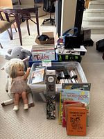 Overview of toys, children's books, and vintage records including a doll and plush elephant