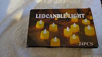 Top view of the closed box of 24 LED candle lights showing product image and quantity