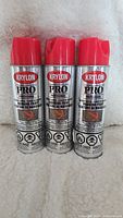 Three Krylon Pro Professional marking paint cans with red spray caps, front view showing product label and warnings.