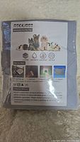 Image of packaged RIOUSSI washable pet pee pads showing front of packaging with product features and pet images.