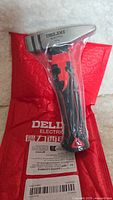 Delixi electric hammer in original plastic packaging on red branded pouch