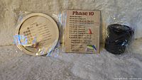 Phase 10 game score boards and dice cup unopened in packaging