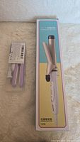 Photo showing boxed white hair curler with brand and model number Crasty 1039