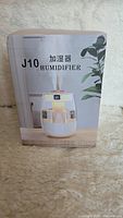 Front of the J10 humidifier box showing the product image and model name.