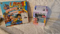 Image showing Lava Escape Game box and Number Safe box side by side.