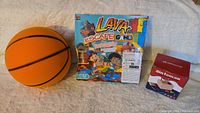 Photo showing all three items: basketball, Lava Escape board game, and 2-in-1 color puzzle box