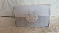 Box front showing a line drawing of the neck massager device and the text 'Neck massager'.