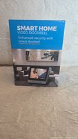 Front view of the product box showing Smart Home Video Doorbell branding and a photo of the indoor video display unit.