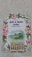 1907 January calendar with floral border and rural scene from Roth & Santee Dry Goods, Watertown, New York