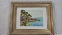 Full view of the 14 x 18 inch framed art print showing the coastal landscape artwork and gold-toned frame.