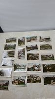 21 hand-coloured postcards spread out showing various mountain and hotel scenes in the Canadian Rockies.