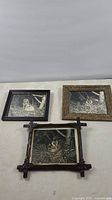Three framed 8x10 inch black and white photos of an owl nesting, displayed on a wall.