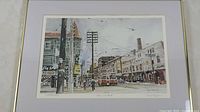 Framed print showing a city street with buildings, a streetcar and pedestrians at Queen and Church.