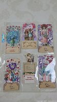 Top view of six vintage fold out Valentine cards with children, flowers, and heart themes in plastic sleeve.