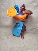 Front view of Two Bad figure with blue and purple heads, orange armor and shield.