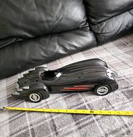 Side view of the 1997 Kenner Batman & Robin Batmobile toy showing sleek black design and length measurement around 14 inches.