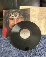 Front cover with close-up portrait of Burton Cummings and vinyl record showing label.