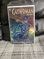 Photo of the Catwoman "Defiant" comic book sealed in a protective sleeve, showing full front cover.