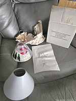 Photo of all items including the painted glass Coca-Cola shade, metal holder, white shade, instruction sheet and box.