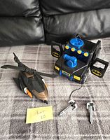 Batman helicopter and vehicle toy shown with Lot 10 note