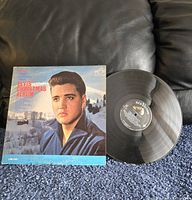 Front of Elvis Presley Elvis Christmas Album showing album cover with image of Elvis outdoors in a winter scene and the vinyl record with RCA Victor label.