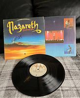 Front view of the vinyl record and album cover with Nazareth name and art showing sunrise background and band photos.