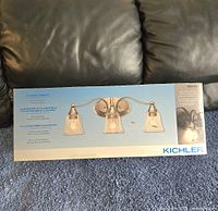 Box of Kichler 3-light vanity light fixture showing the full product packaging with an image of the fixture on the front.