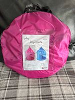 Pink round carrying bag with label showing pink and blue Royal Castle tents by Kidsquad